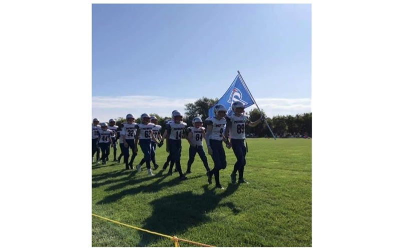 Our players walking out onto the field with our flag.